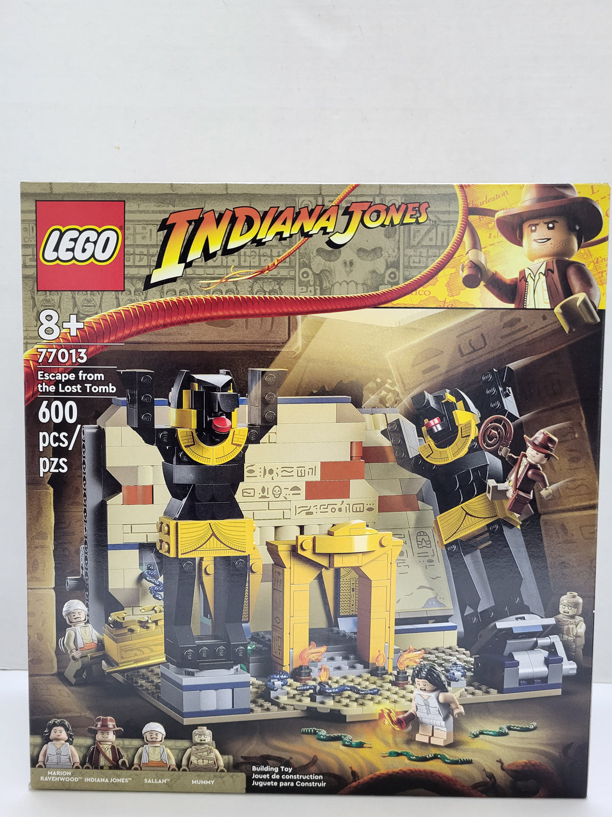 LEGO Indiana Jones Escape from the Lost Tomb building set box, showing the illustrated product scene with Indiana Jones minifigure, robot figures, and a desert tomb setting. The box is photographed against a plain light background.